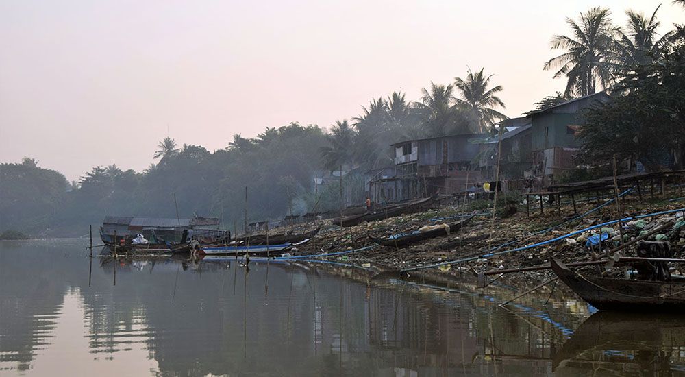 Houten huizen op palen langs rivier bij Battambang